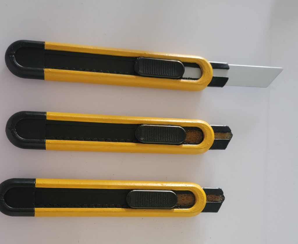Yellow box-cutter props with retractable and soft stunt blades