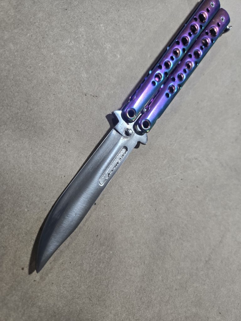 Stunt-safe butterfly knife prop with purple handles and silver blade