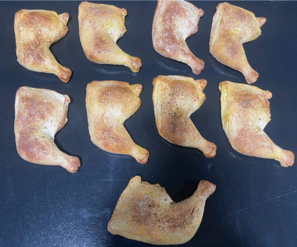Realistic prop roasted chicken legs arranged for film production
